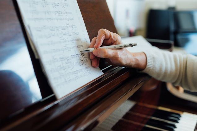 Writing notes on a music sheet
